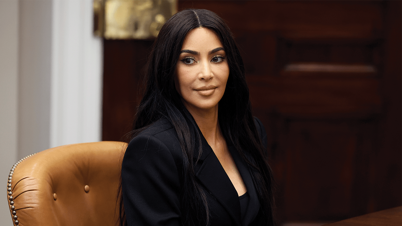 Kim Kardashian at the White House with dark brown hair.